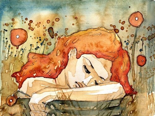 Kobieta z czerwonymi włosami siedzi smutna