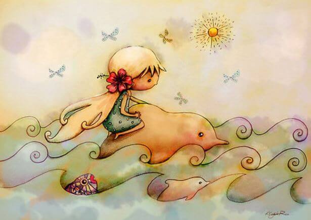 Dziewczynka płynie z delfinami.