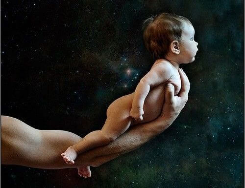 Ojciec trzyma dziecko na ręku, prezentując je światu