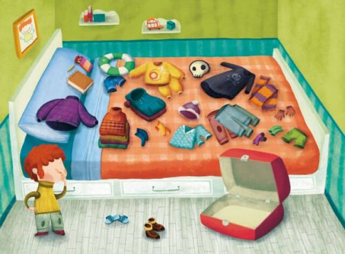 Chłopiec pakuje walizkę