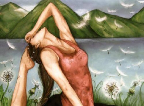 Kobieta praktykuje jogę nad jeziorem