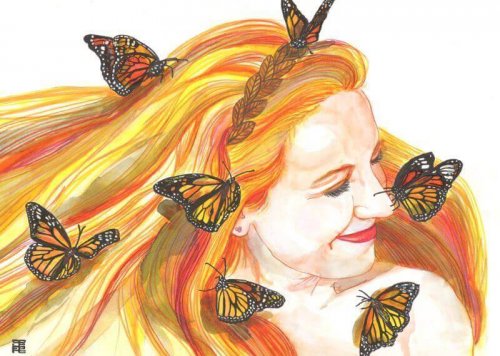 Szczęśliwa kobieta z motylami we włosach.