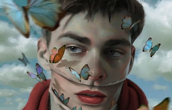 chłopak otoczony motylami