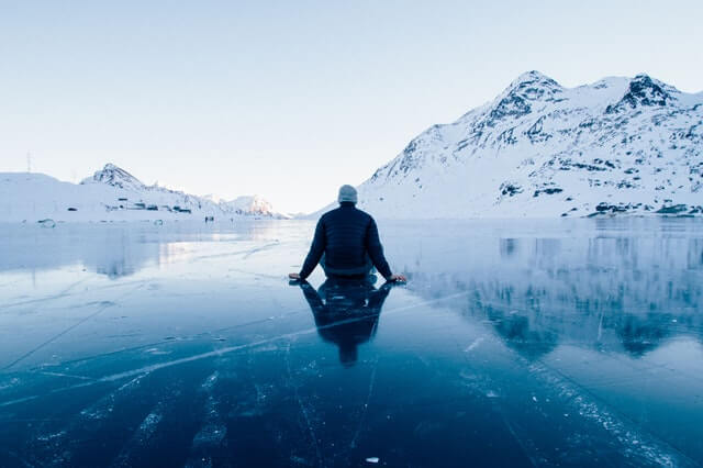 mężczyzna siedzący na lodzie