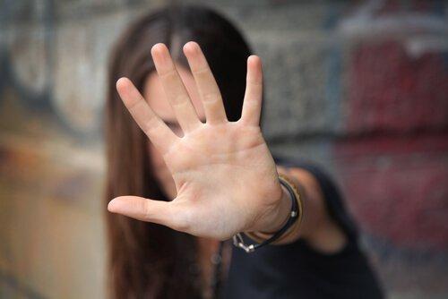 Nietolerancyjni ludzie - kobieta trzyma dłoń w geście STOP