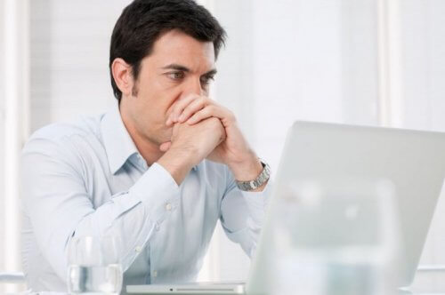 Mężczyzna siedzi przed laptopem - utrata pracy