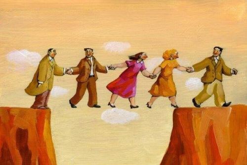 Ludzie trzymają się za ręce, żeby przejść nad przepaścią