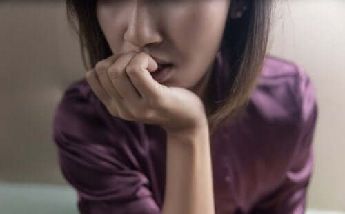 Kobieta obgryzająca paznokcie